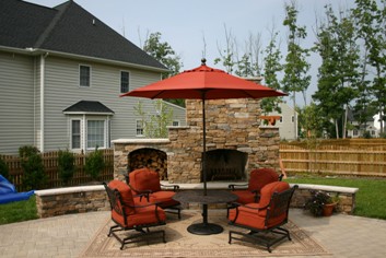 Stone Outdoor Fireplace with Wood Box and Seating Walls