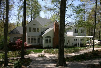 House in a woodland garden with paths