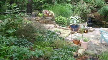 Stone patio and walls with lush plantings