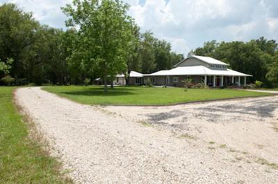 The driveway to the garage and front of the house