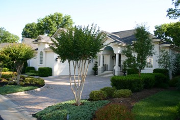 Urban Front Yard with a concrete paver driveway.