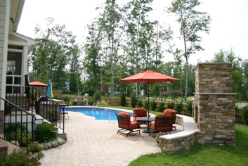 Stone Outdoor Fireplace by a Pool