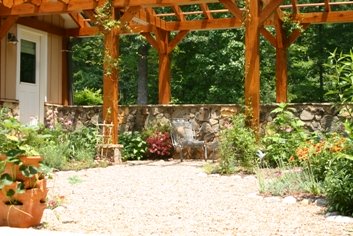 cottage garden with pergola and stone wall